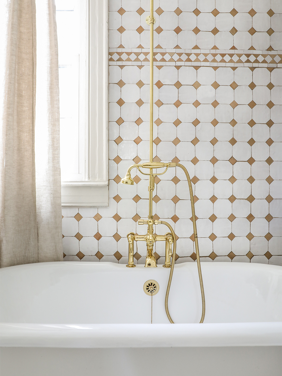white and terra cotta zellige tiles behind bathtub
