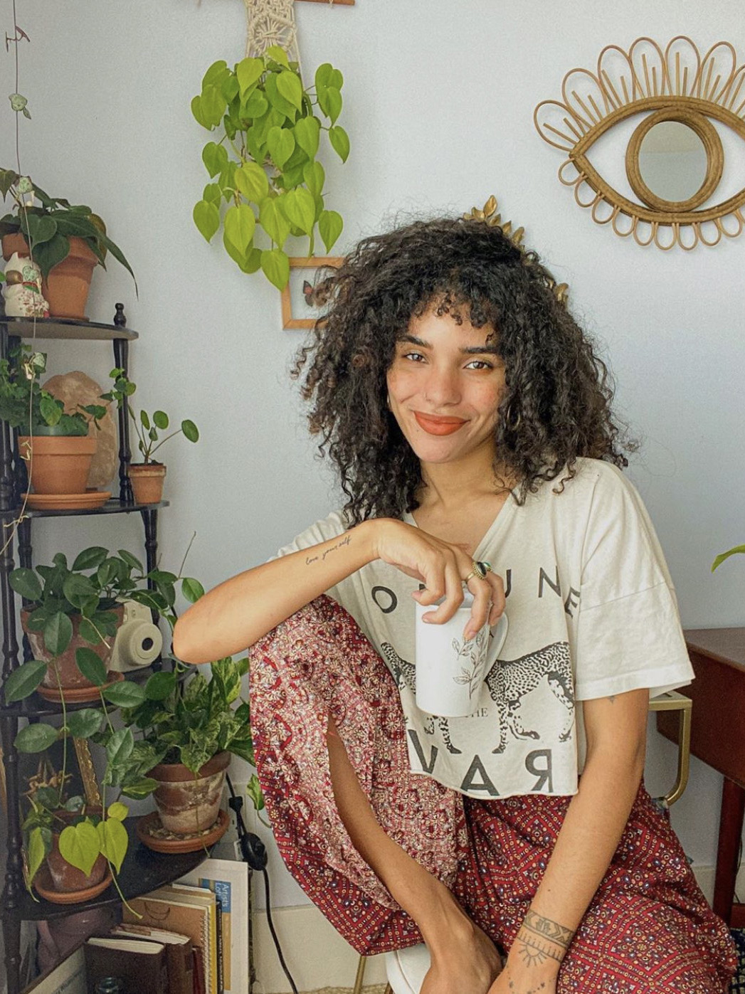 woman sitting in room with plants