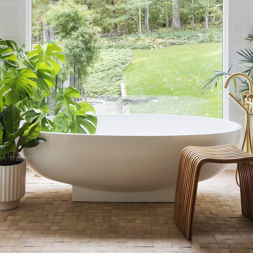 tub surrounded by plants