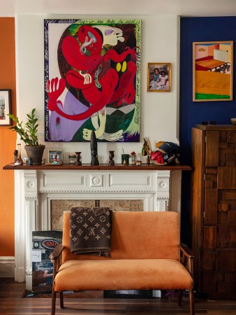 Orange sofa in front of mantel