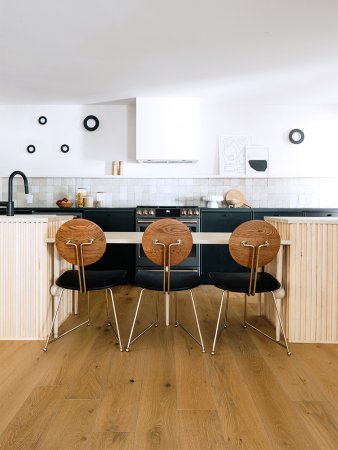 black and white kitchen with wooden ribbed island