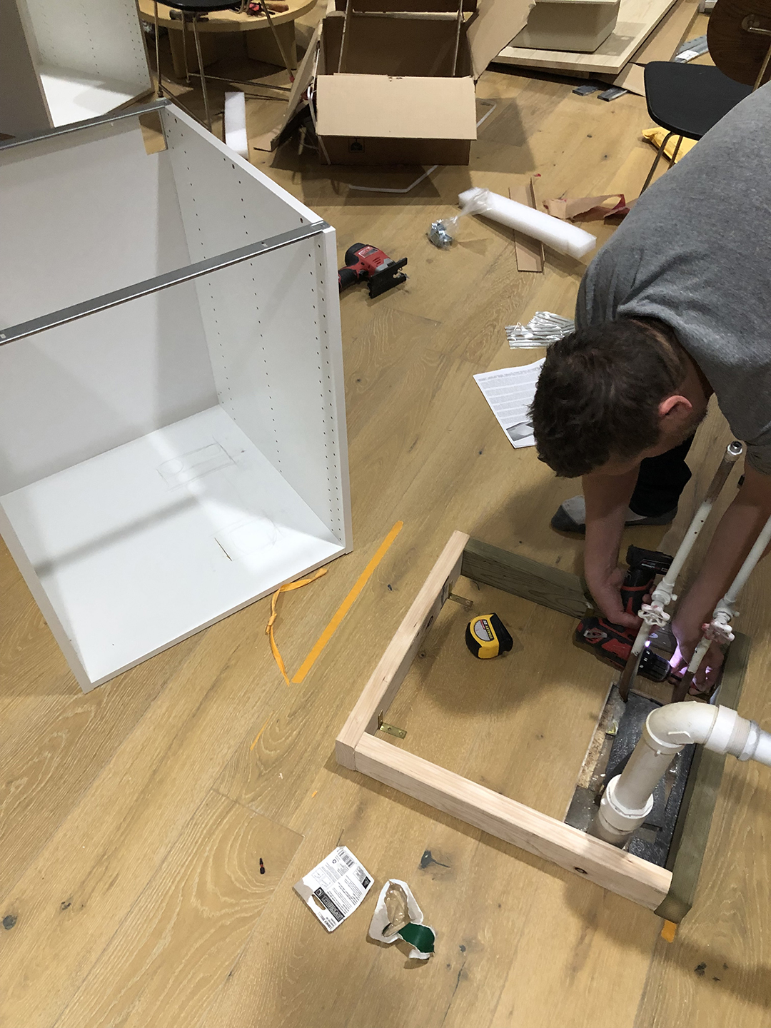 man putting together cabinet