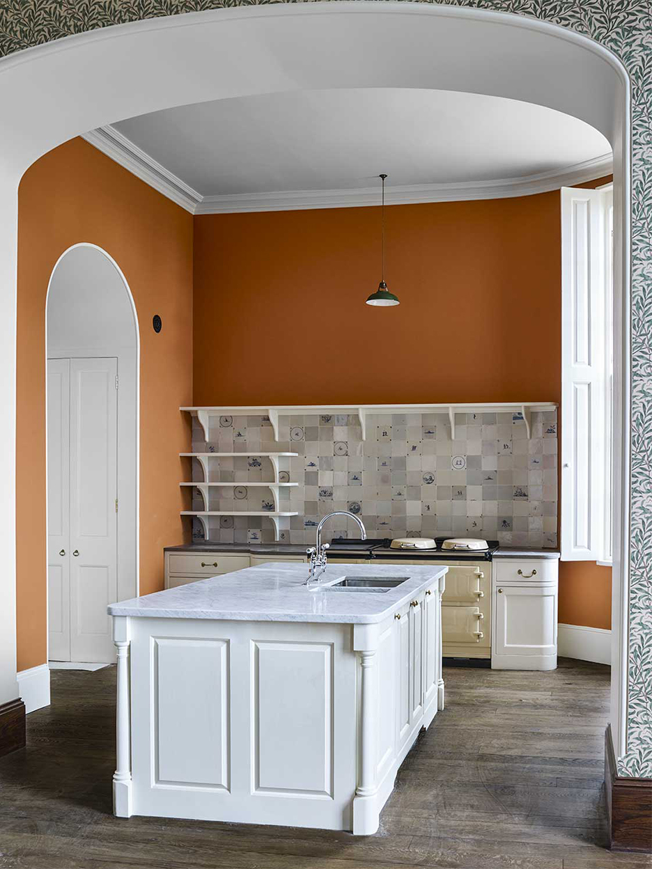 orange kitchen with white cabinets