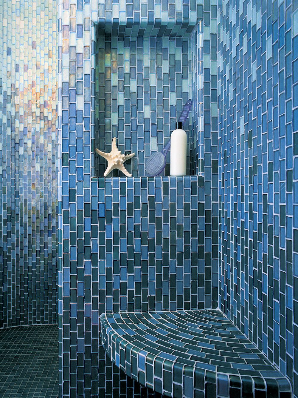 blue ombre tile bathroom with recessed wall nook for shampoo