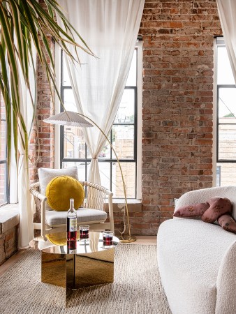 room with brick wall and white chair