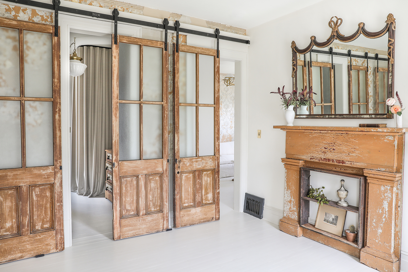 room with sliding barn doors and matching mantel