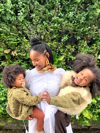 woman holding two kids