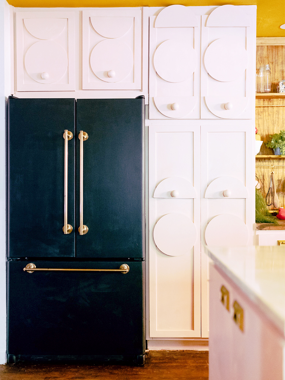 black fridge with white cabinets