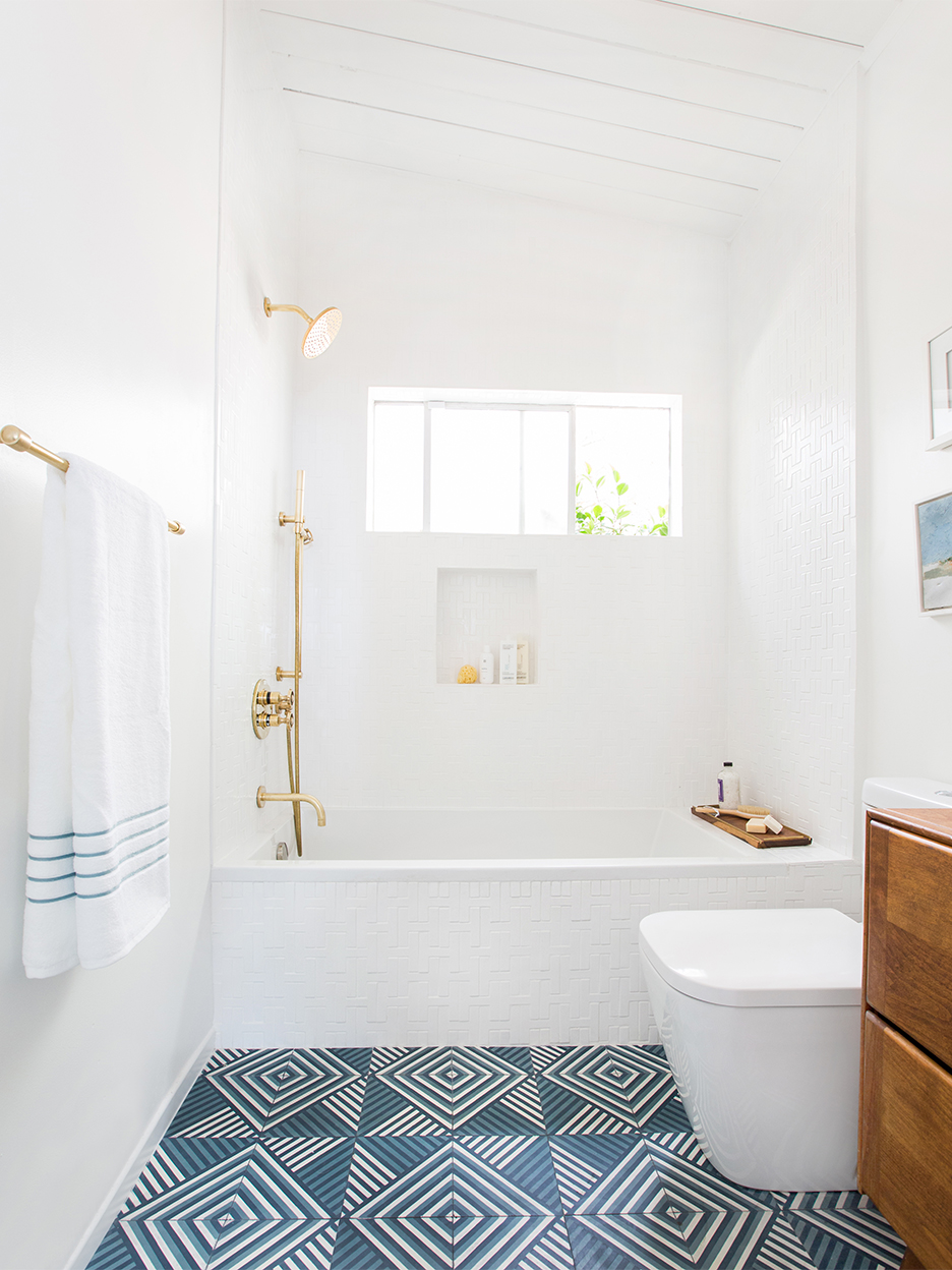 white bathroom with blue retro graphic floor tile