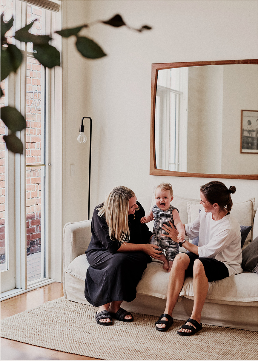 Caroline and her family on a sofa