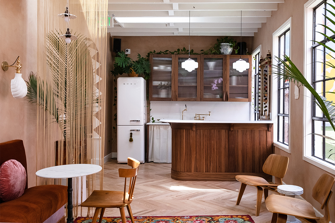 open kitchen dining room with wooden island and beaded curtain