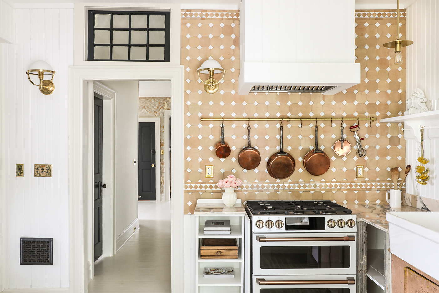 terracotta kitchen with copper pans above oven