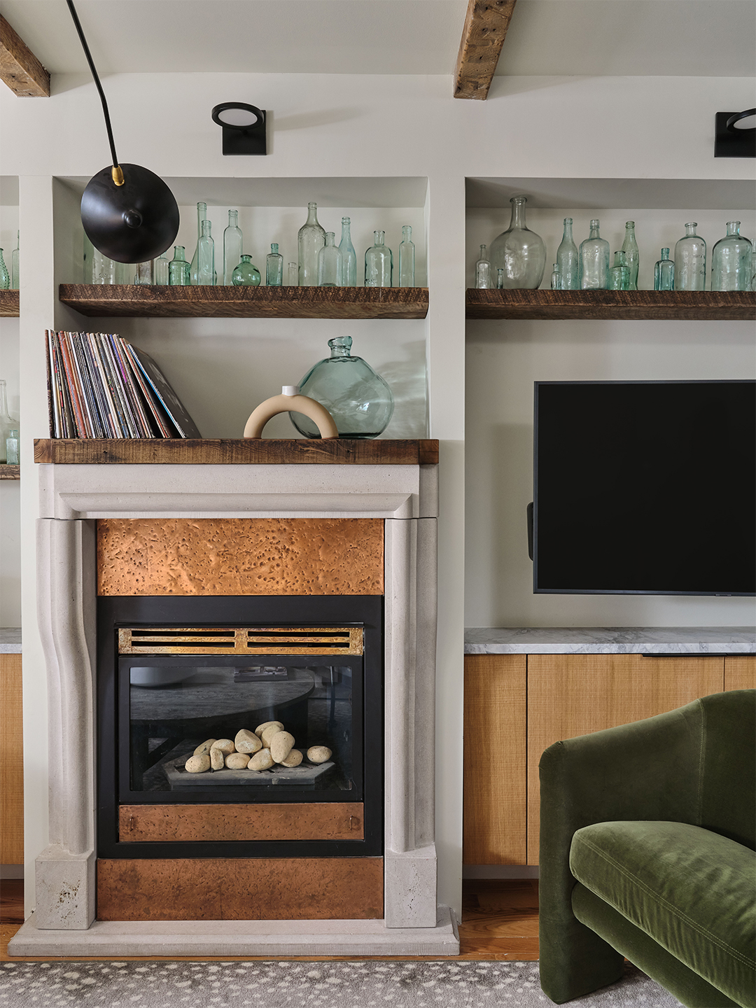 cozy living room wall lined with glass bottles