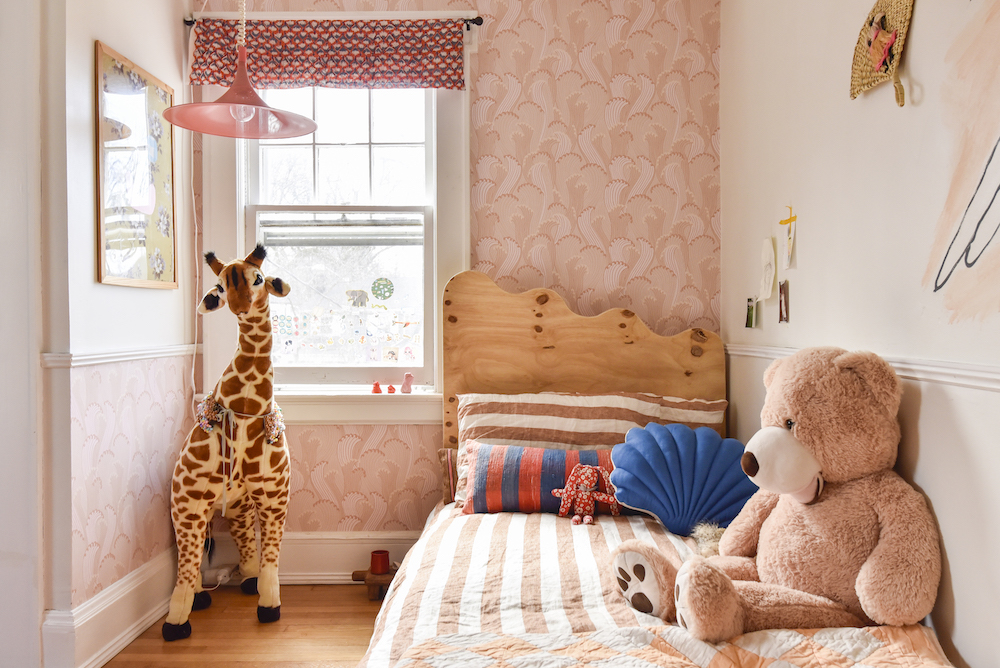 Kids room with wavy headboard and pink wallpaper