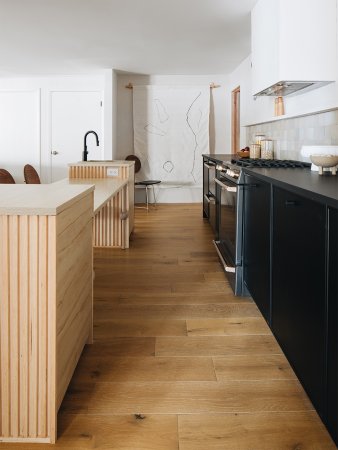 black and white kitchen with wooden island