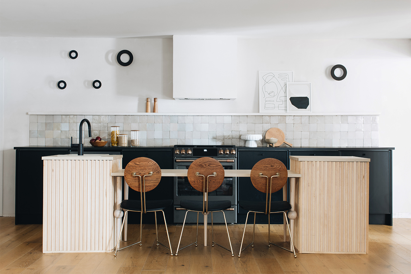 white kitchen with wooden island and black cabinets