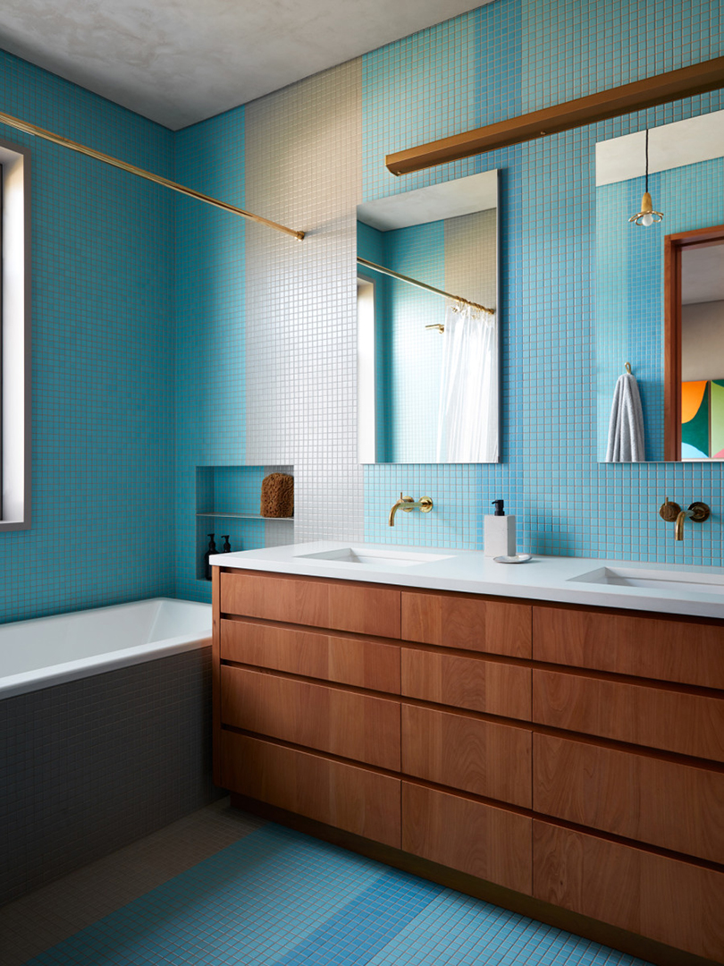 blue tile wall in bathroom with wood fixtures