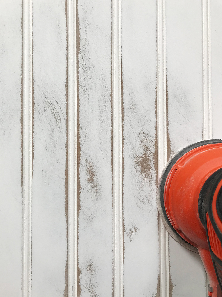 Hand sander sanding trim