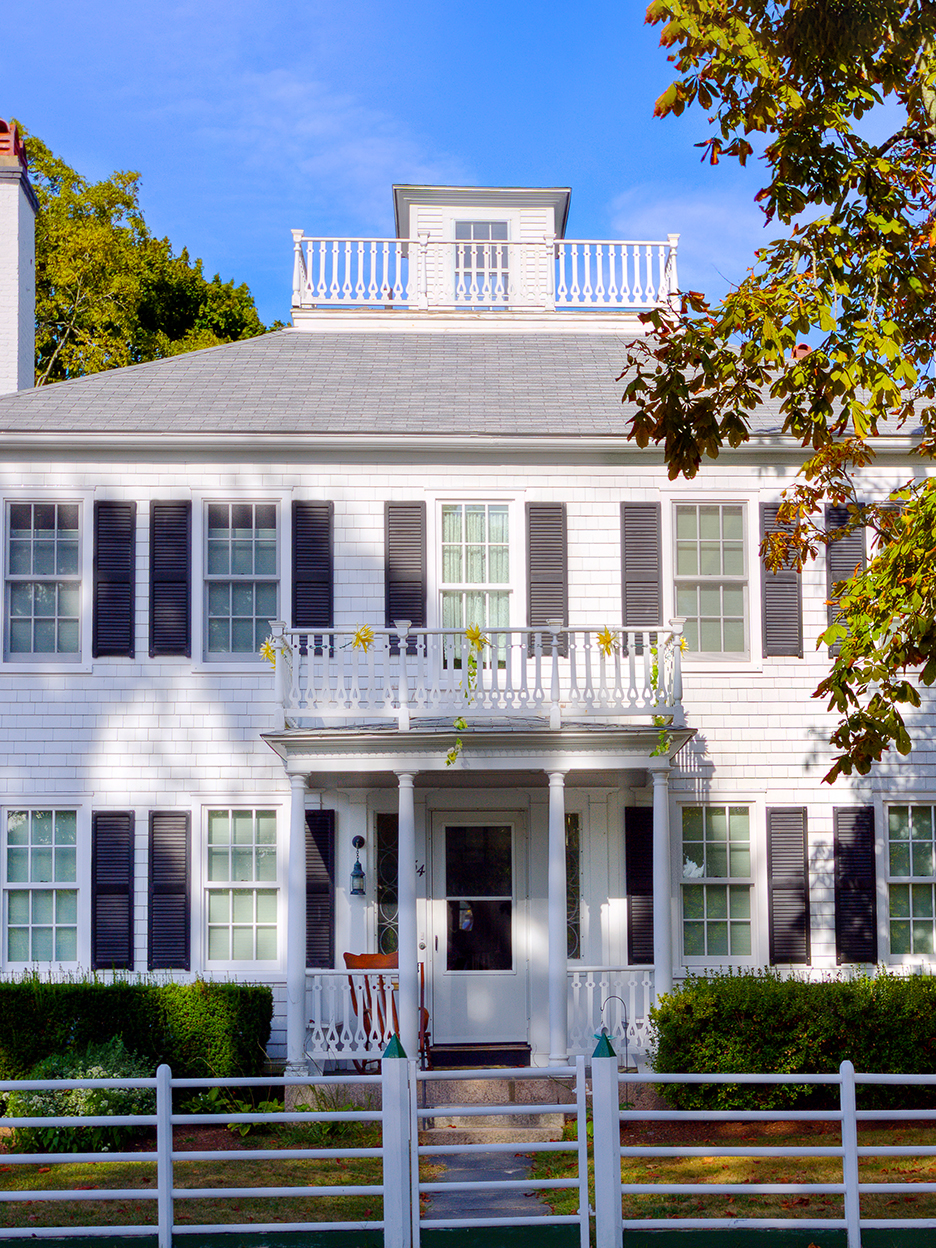 white house with balcony front porch