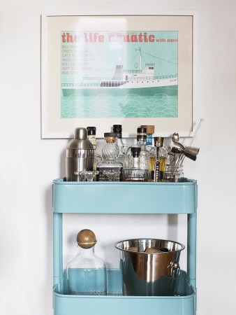 blue bar cart beneath artwork