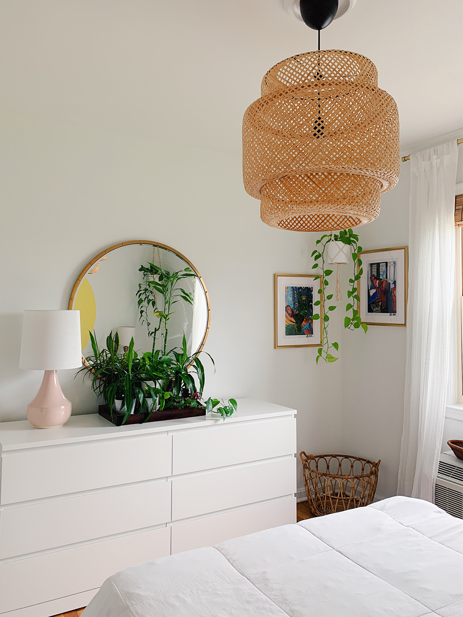 white dresser in bedroom with rattan pendant light