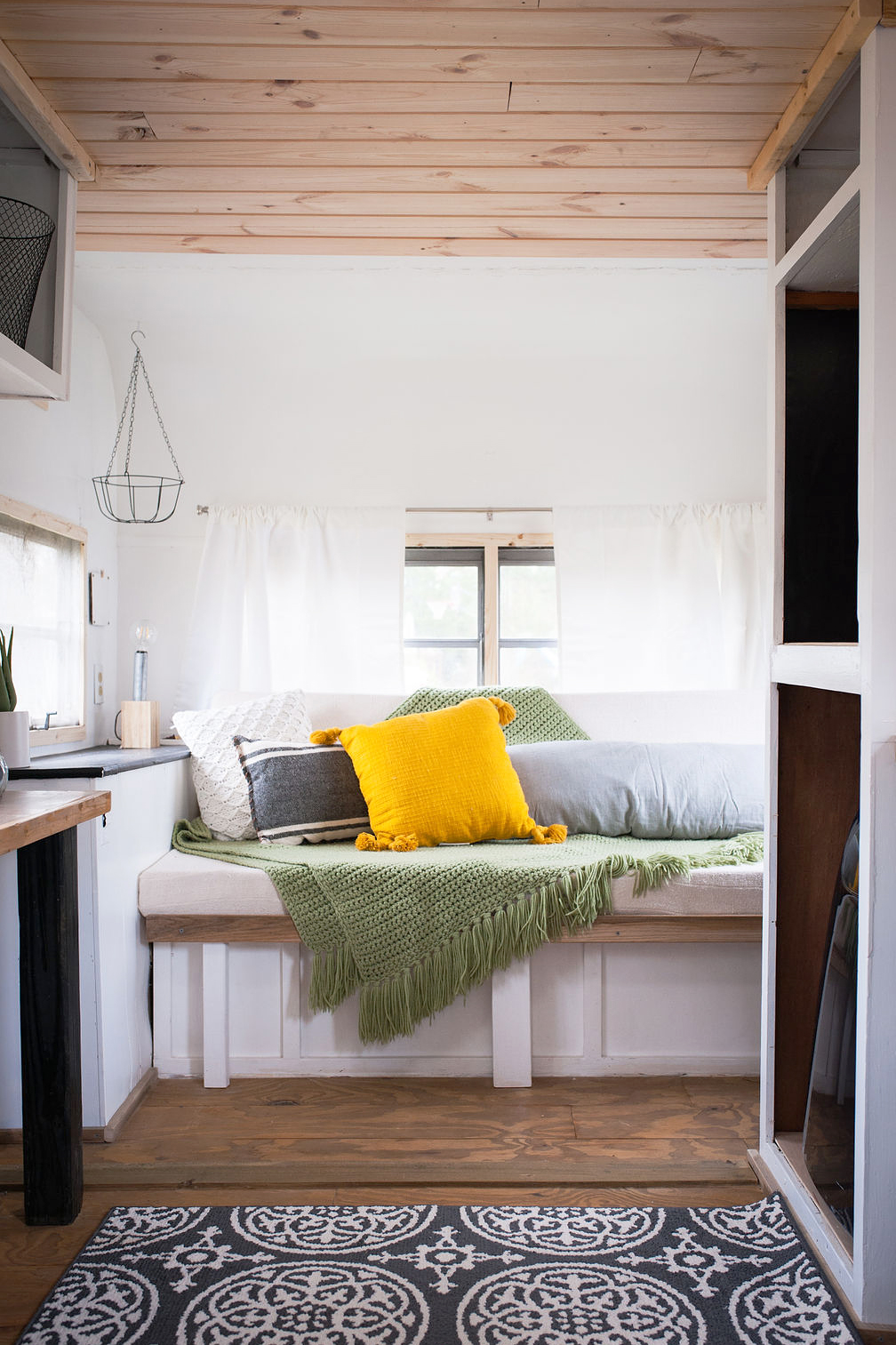 sofa with green blanket in rv living room