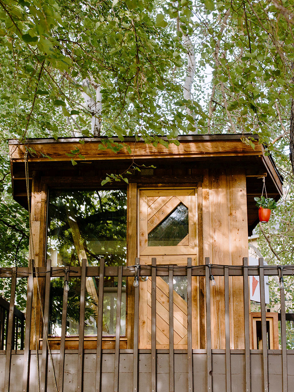 brown treeehouse with deck