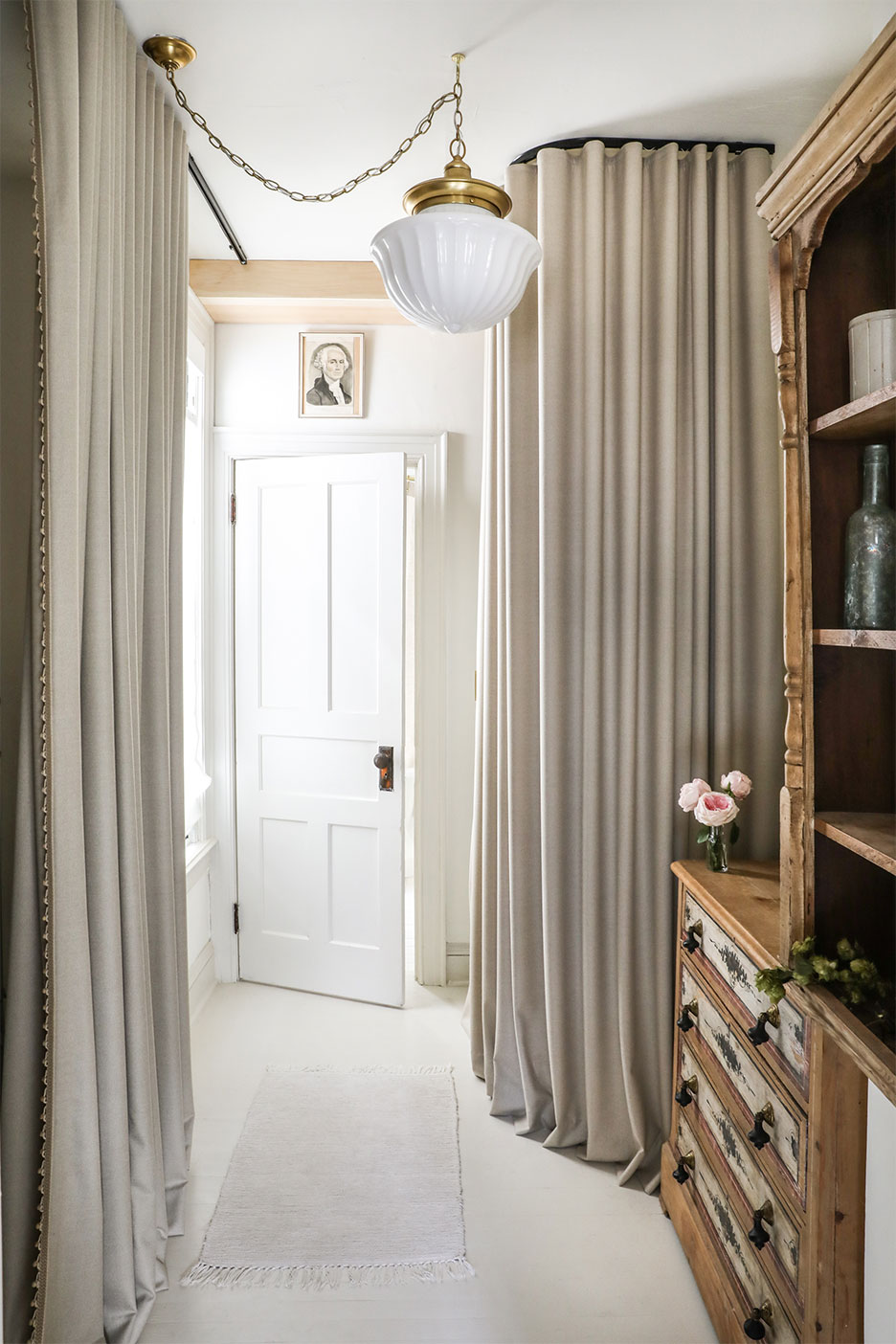 narrow room with two curtain panels