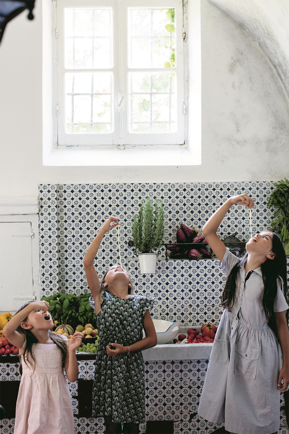 kids in kitchen eating pasta