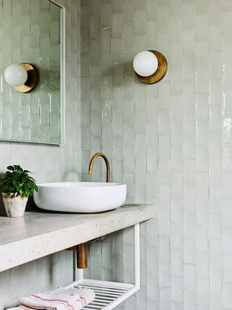 Green tiled bathroom with concrete countertop