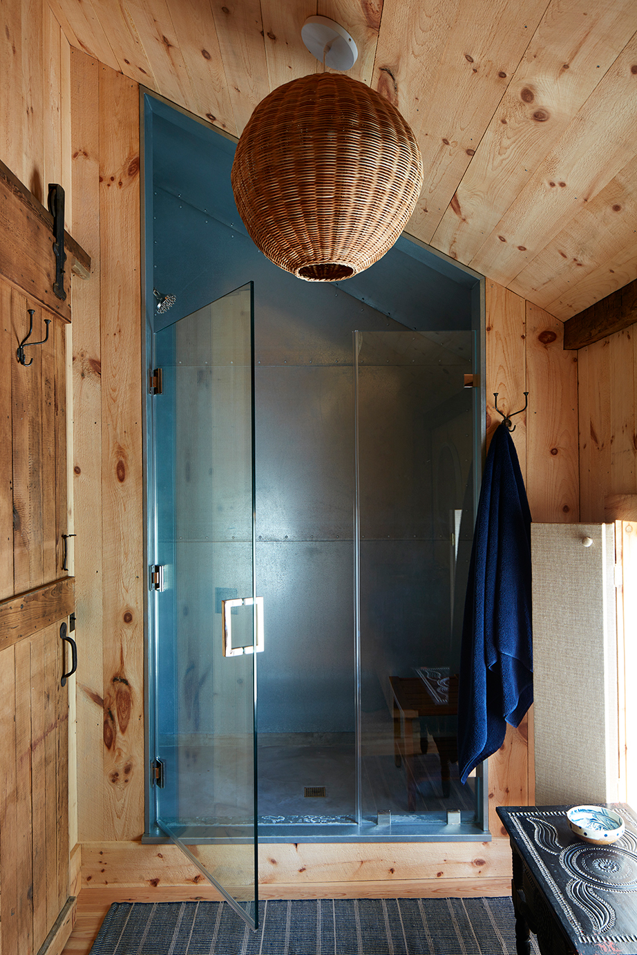 Wood-paneled bathroom with galvanized steel shower