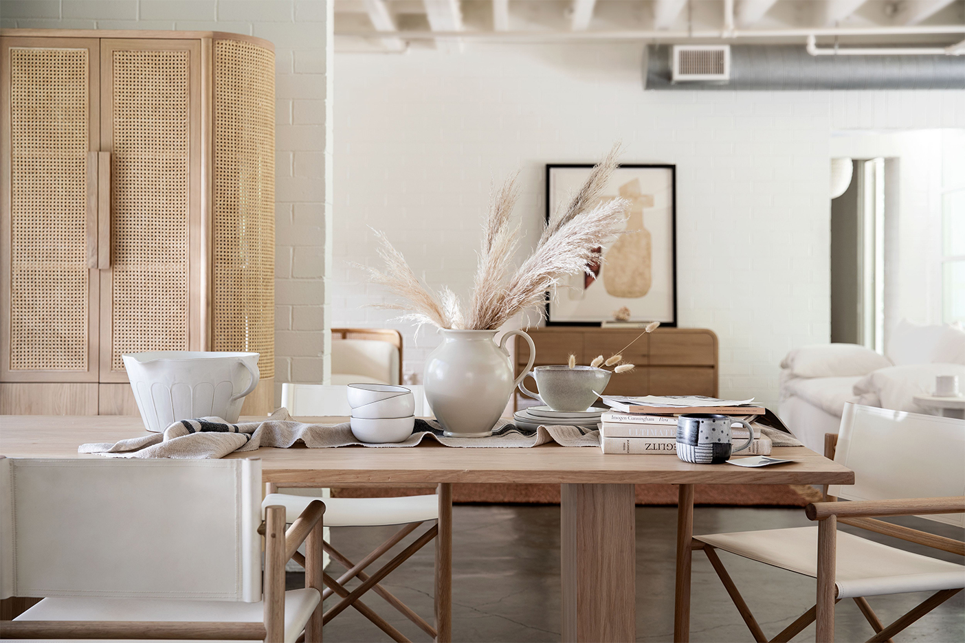 dining room table full of neutral-colored ceramics