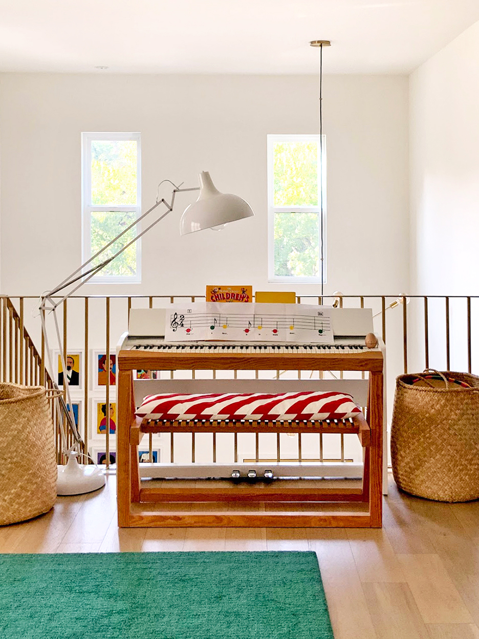 Piano bench with striped pillow