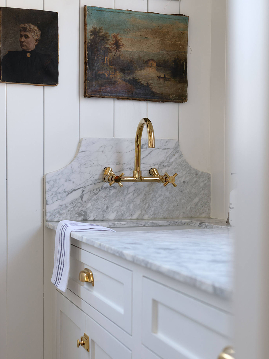 Statement marble backsplash with brass tap