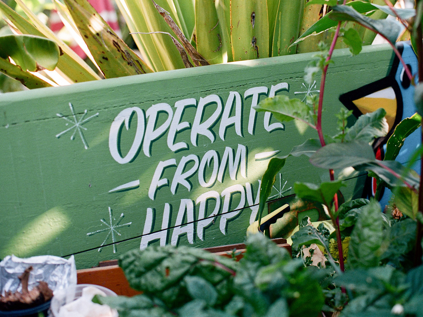 painted sign "operate from happy"