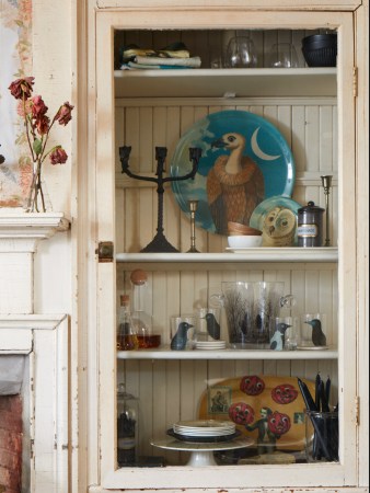 candles and plates on a shelf nookc