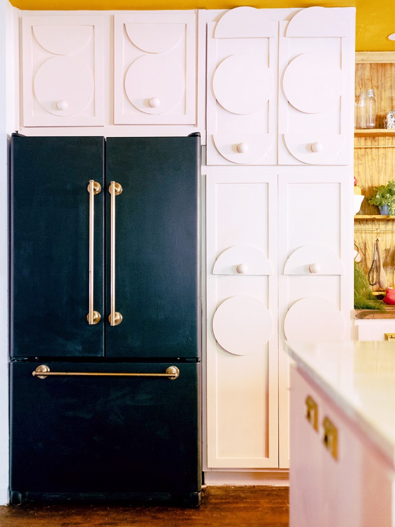 black fridge and white cabinets