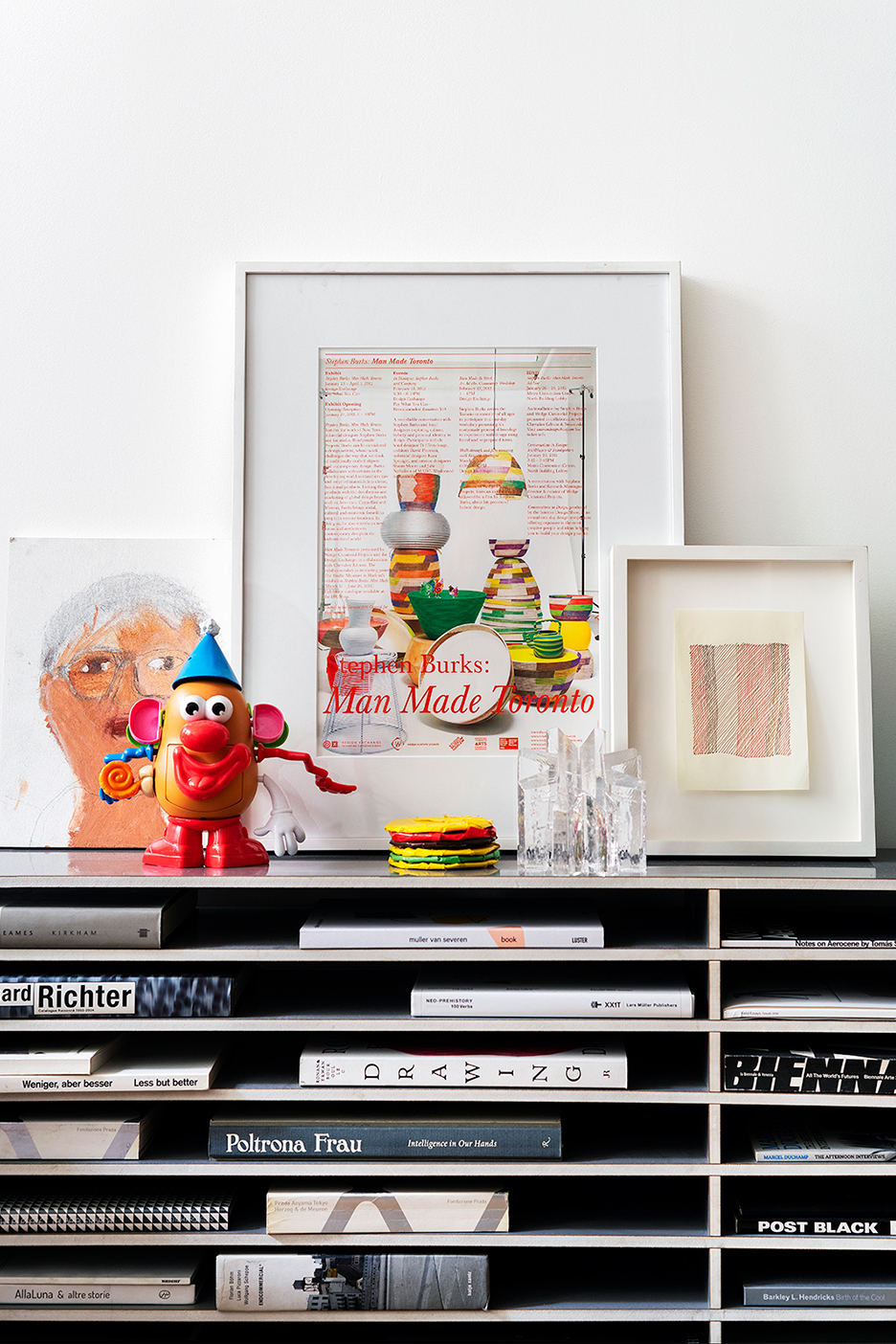 art leaning on top of modern bookshelf