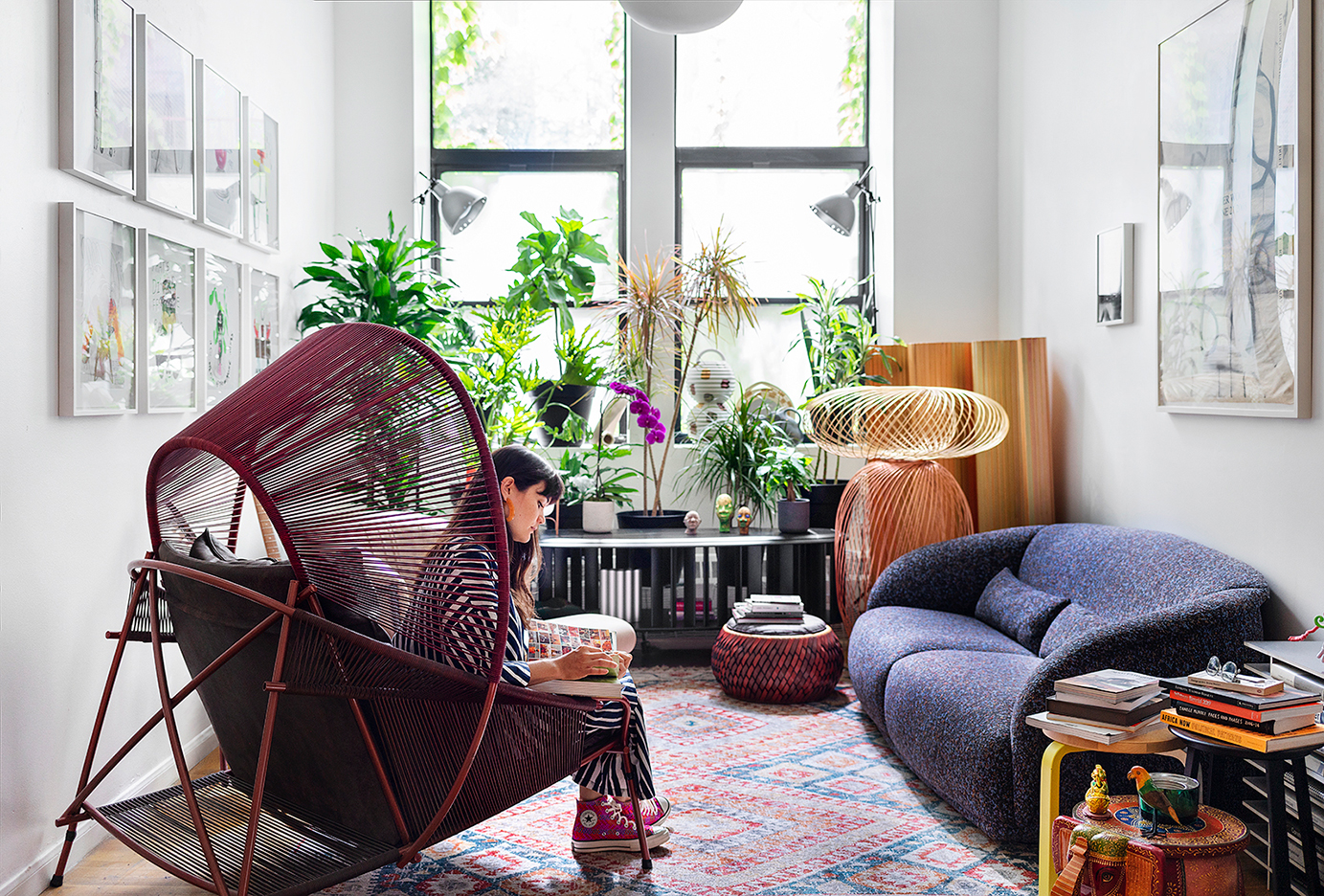 woman reading book in burgundy women chair