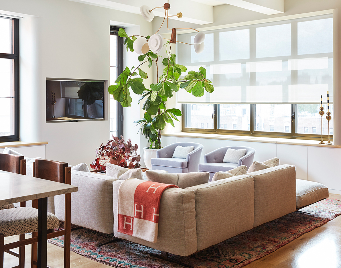 L-shaped cream sofa and lilac armchairs