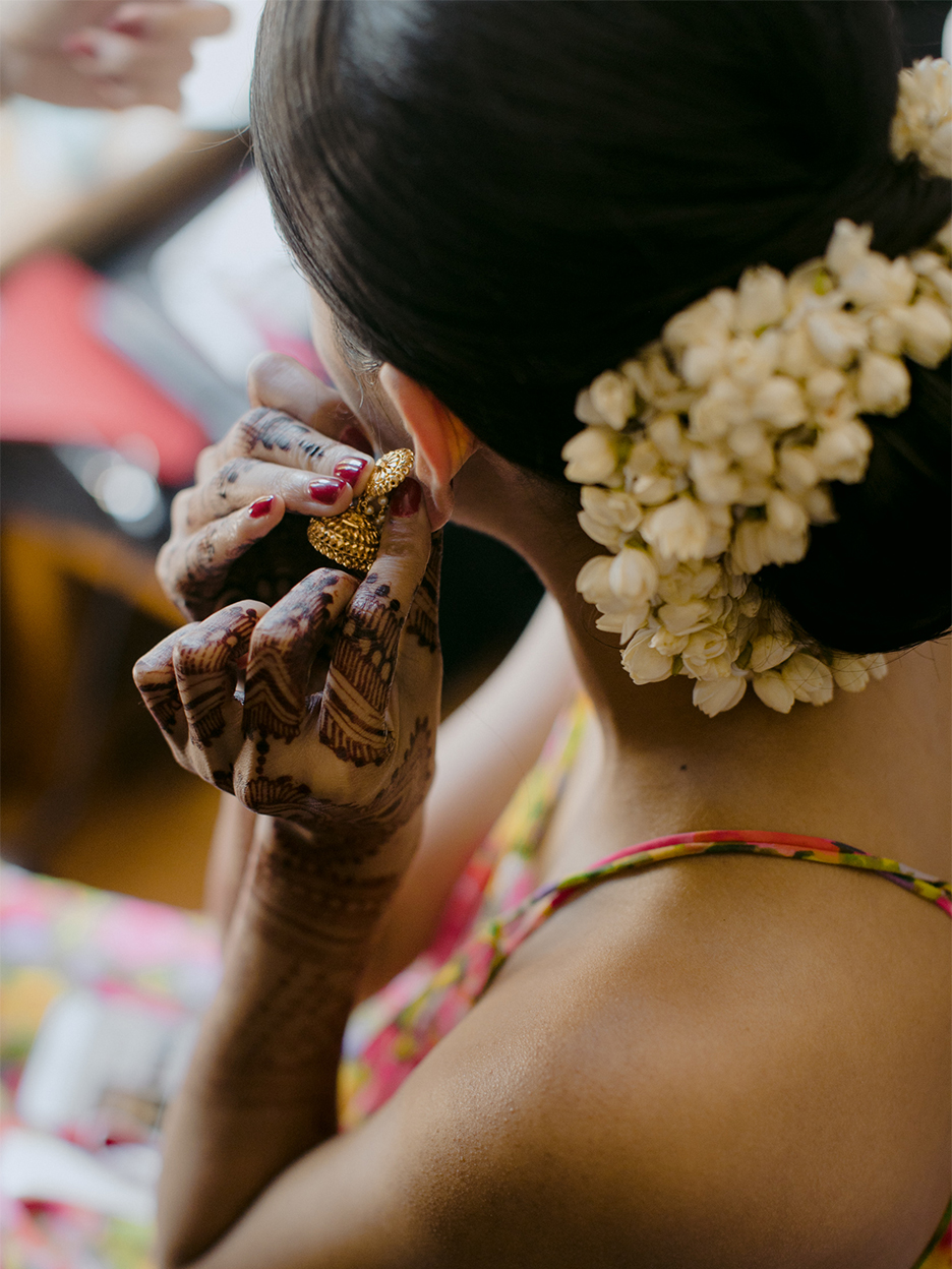 woman putting in earings