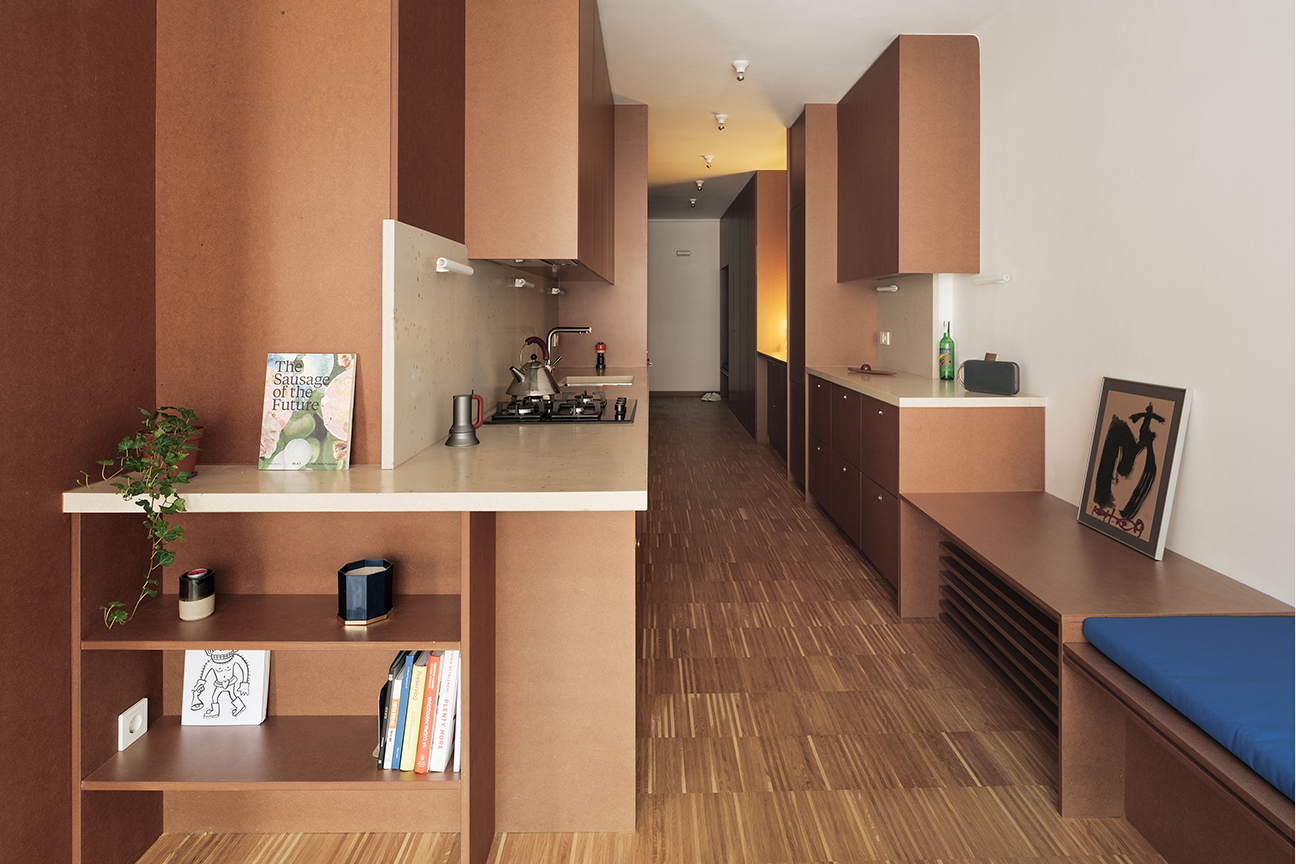 long hallway with brown galley kitchen