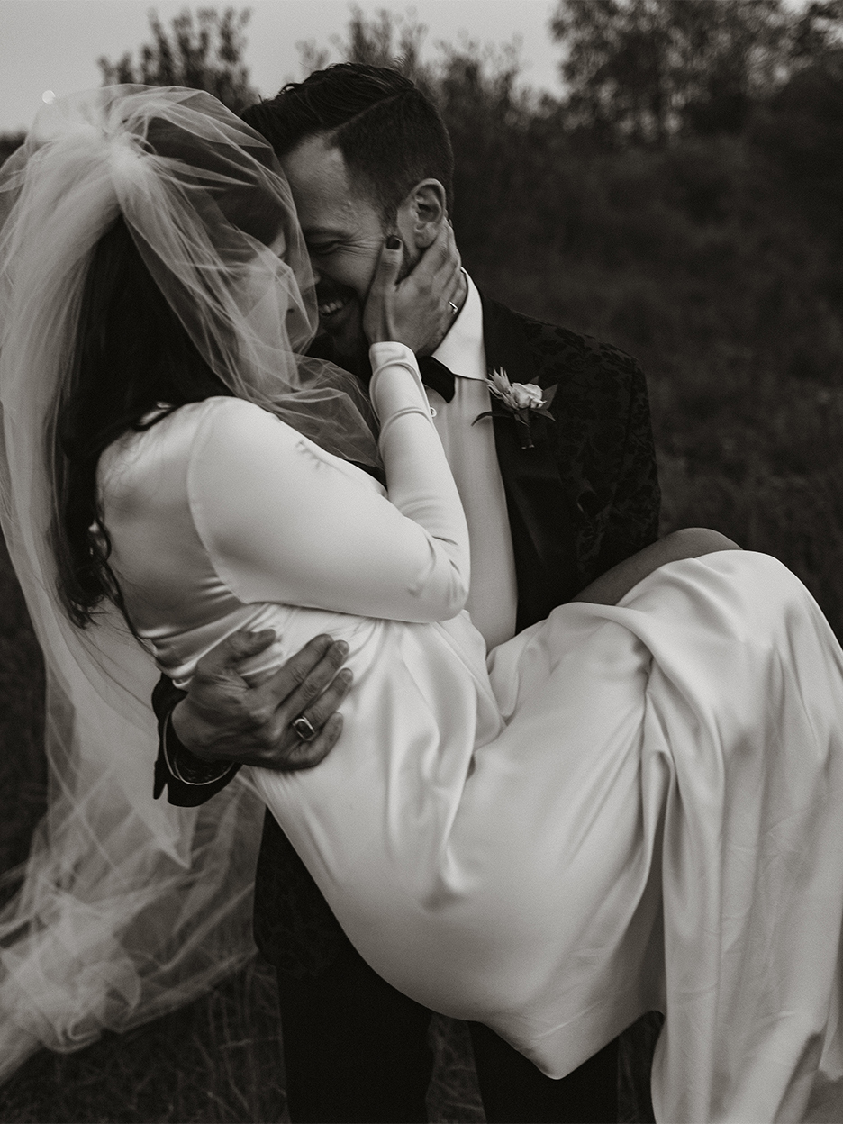 Groom carrying bride