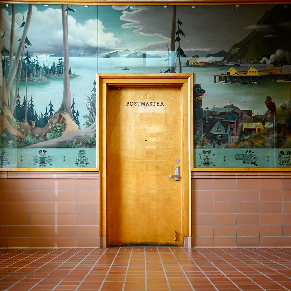 Post office with turquoise wallpaper and terra cotta tile