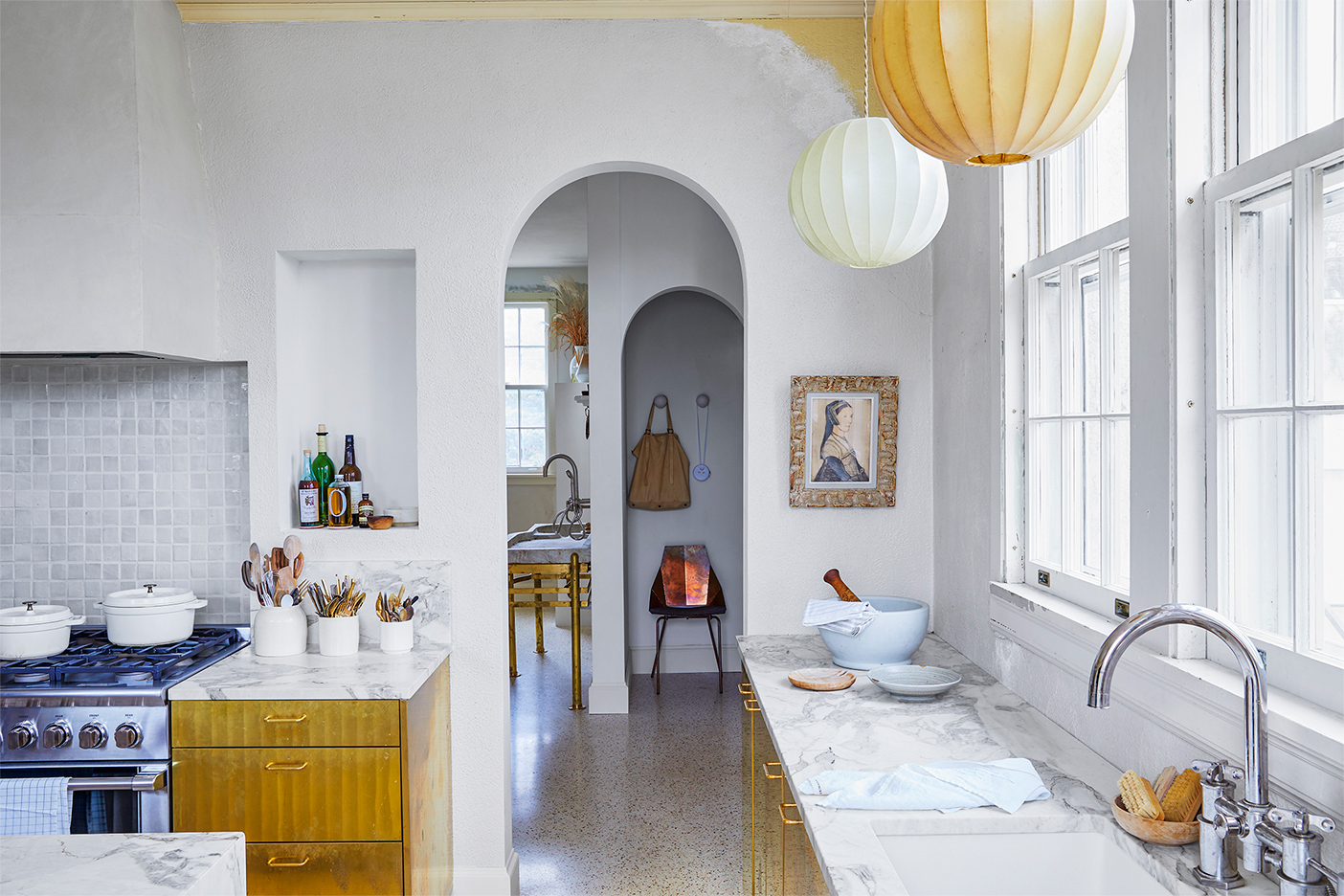 white kitchen with brass cabinets