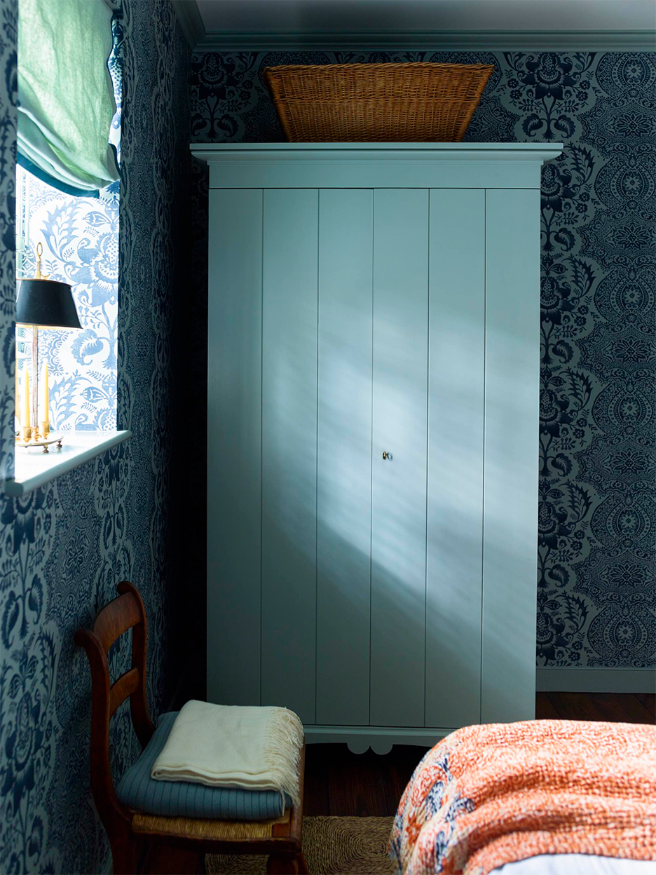 Blue bedroom with soft roman linen shade