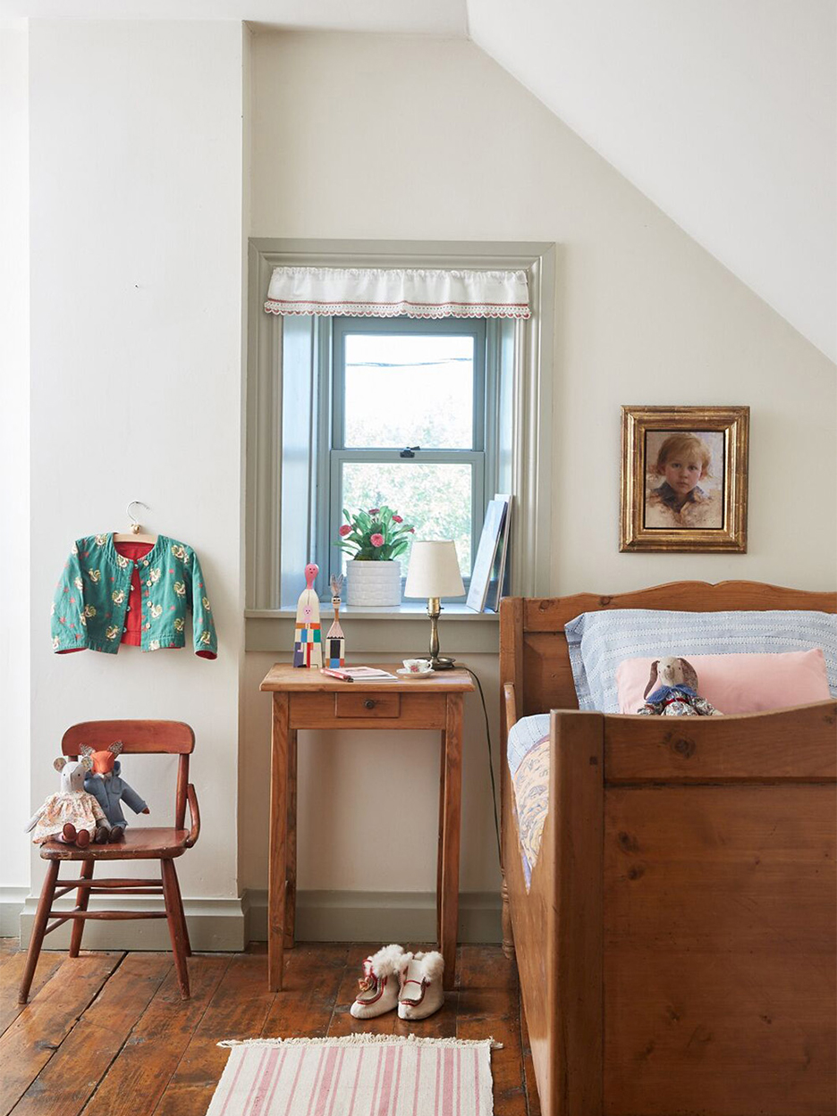 Antique bed in white bedroom