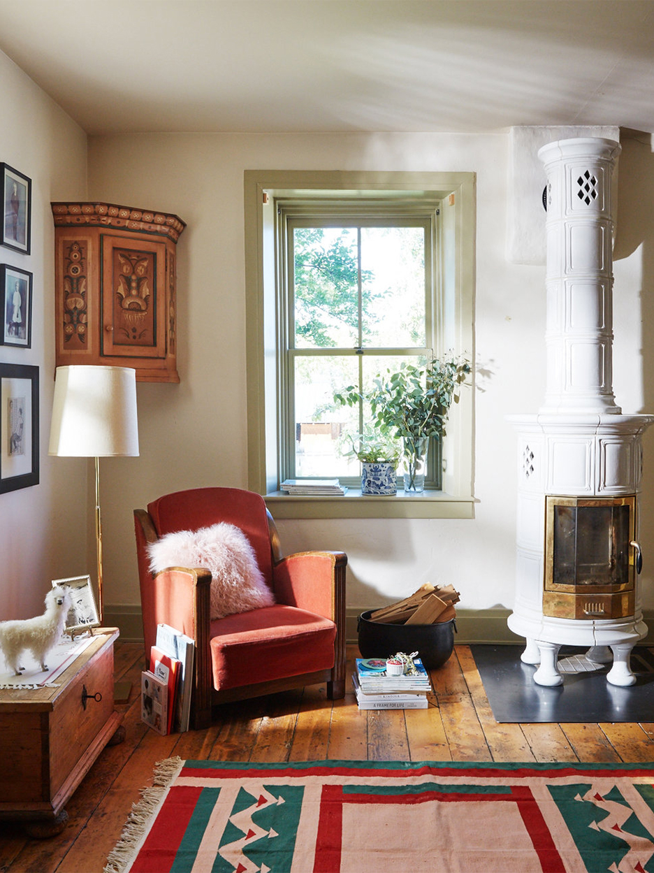 White Scandinavian ceramic stove in pioneer house