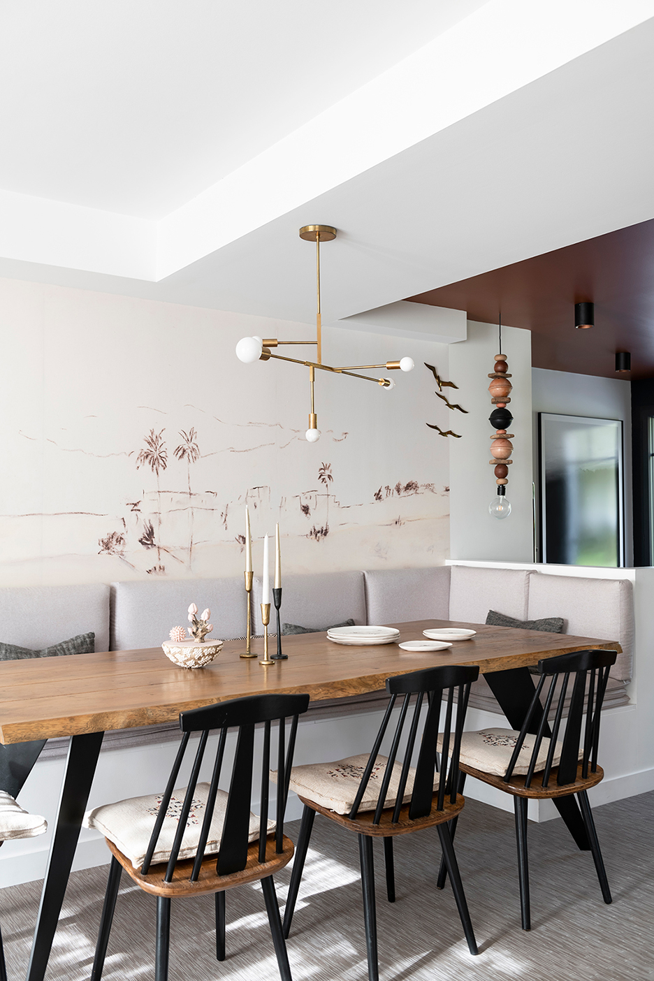 wood dining table with built-in grey banquette