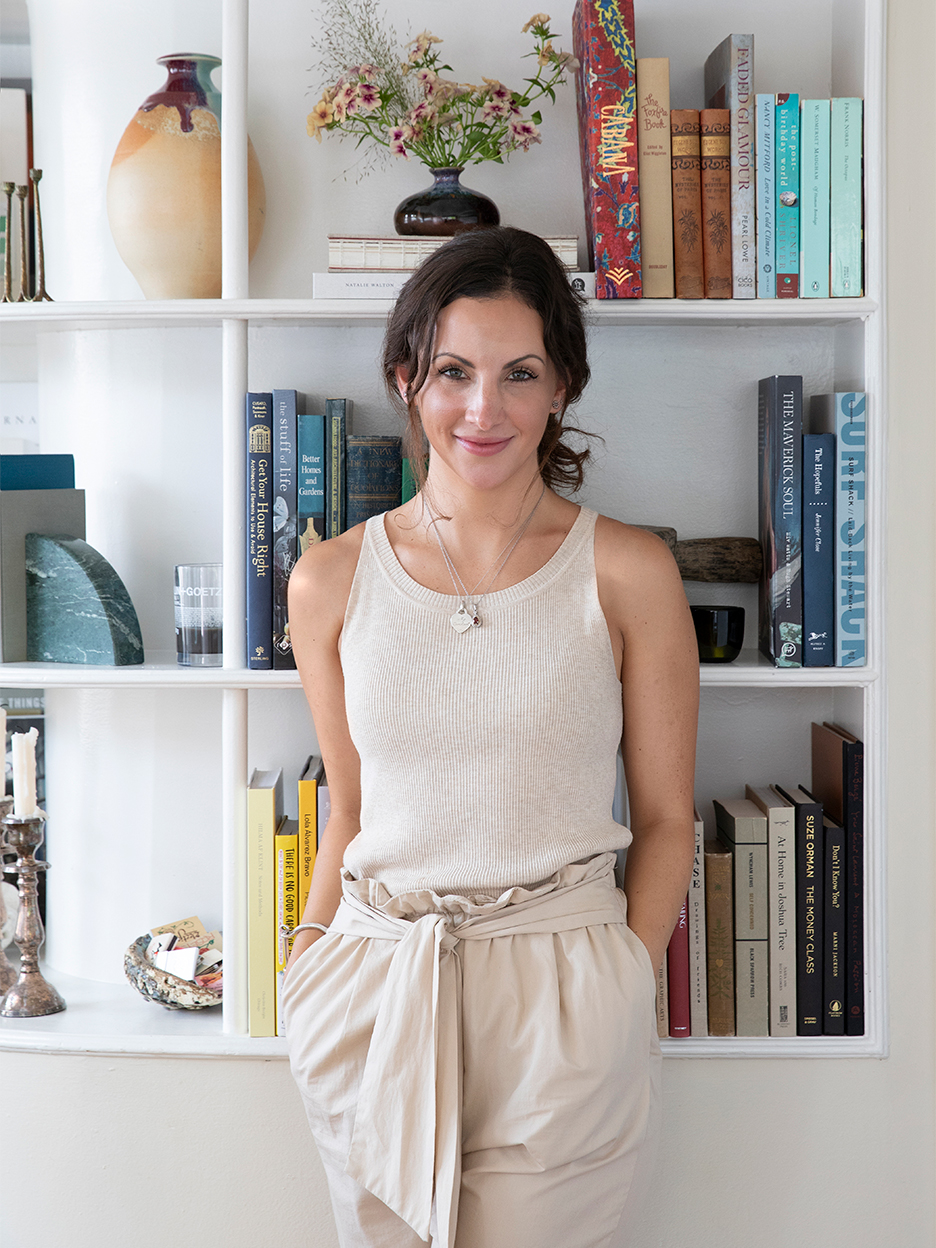 woman leaning on bookshelf